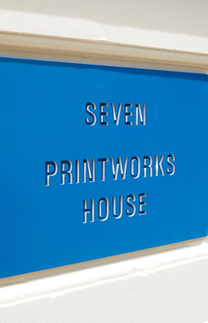 stencil design of 'SEVEN PRINTWORKS HOUSE' on blue