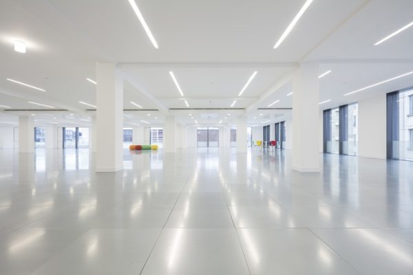 rows of overhead lights reflecting in the tiled floor beneath in this spacious office space in SE1
