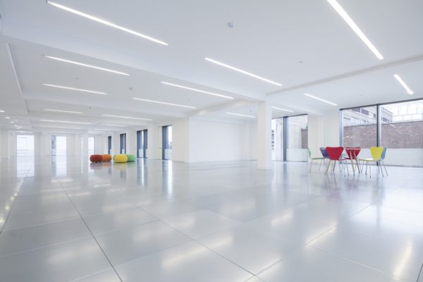 bright and white leasehold office with two circular meeting points of different coloured seats