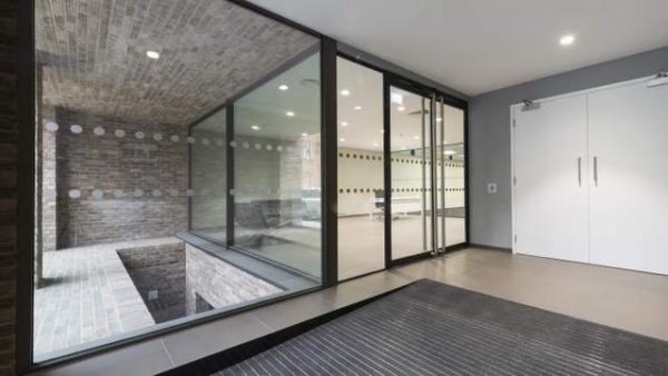 walk in from the outside, a glass double door entrance into the interior of the building