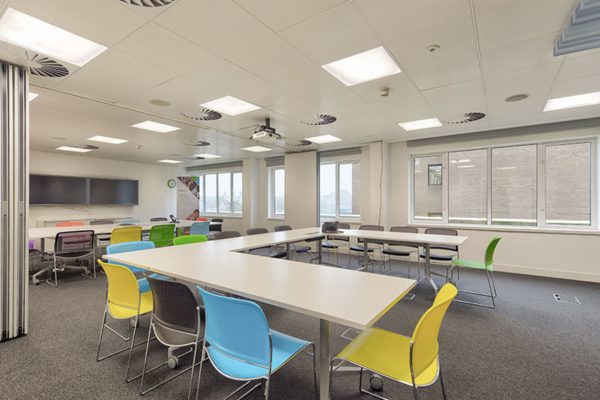 different coloured chairs round u-shaped desks in a meeting room at Shackleton House