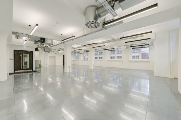 shiny polished floor of airy leasehold office painted white with lamps and natural light